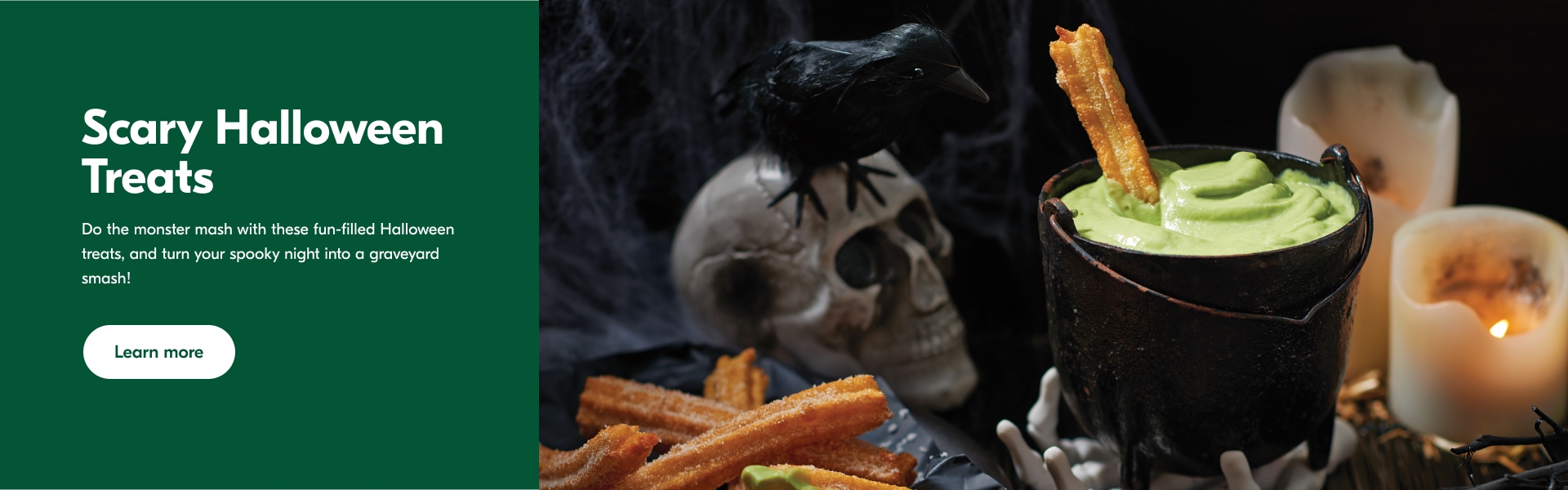 Churros on a blue plate and a bucket of green witches brew dip with various Halloween decor in the background