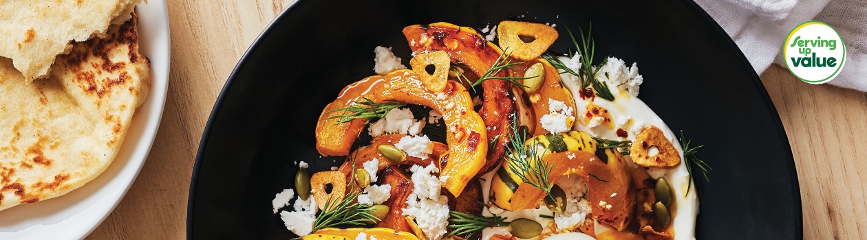 Turkish eggs with squash on dark round scooped plate