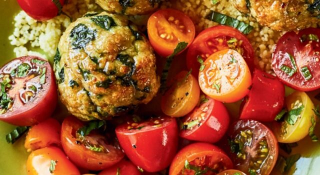 Bowl of turkey and spinach meatballs with sliced grape tomatoes and couscous