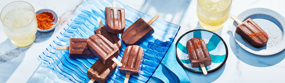 Blue platter of Mexican-inspired Chocolate Ice Pops with tajin spice