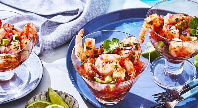 three serving glasses of Spanish-inspired Shrimp Cocktail with lime wedges