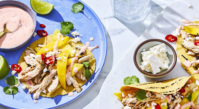 three Tropical Sweet and Spicy Chicken Tacos with mango, cheese, chilis, cilantro and creamy sauce